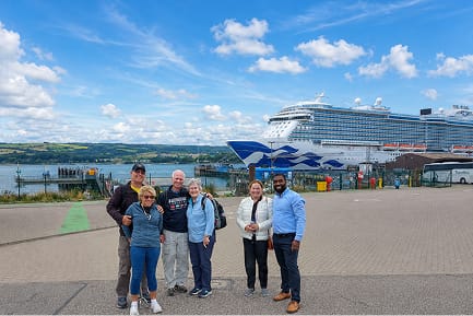 Aleman standing with guests during their custom private Highland journey