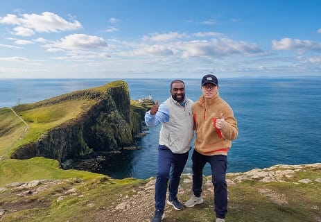 Aleman and guests enjoying a scenic viewpoint on a custom Highland tour