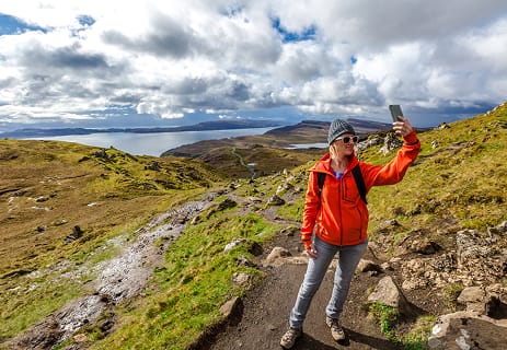 Guests smiling at a scenic viewpoint during an Invergordon shore tour