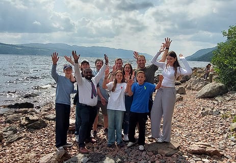 Family group with Aleman beside a scenic Highland loch on a custom tour